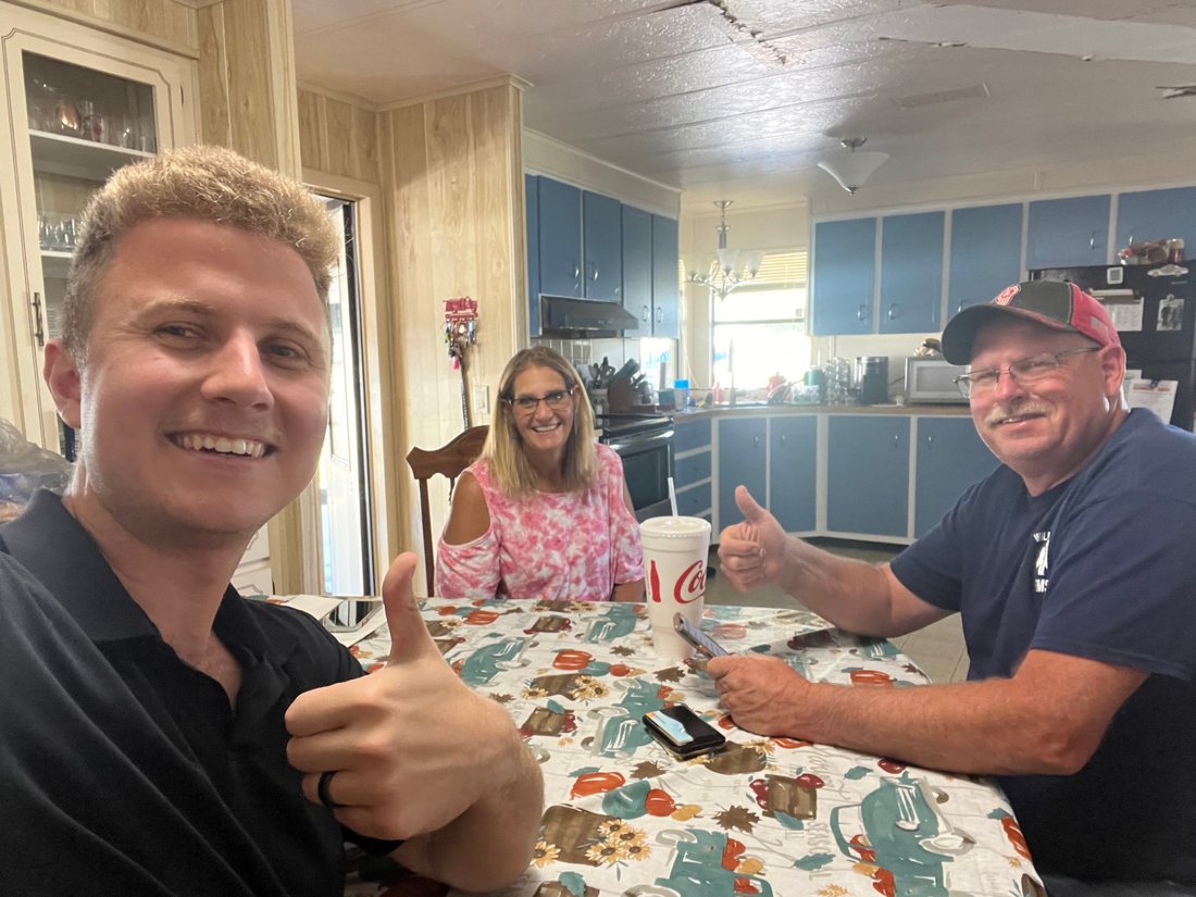 Conner Leeb with homeowners at their kitchen table