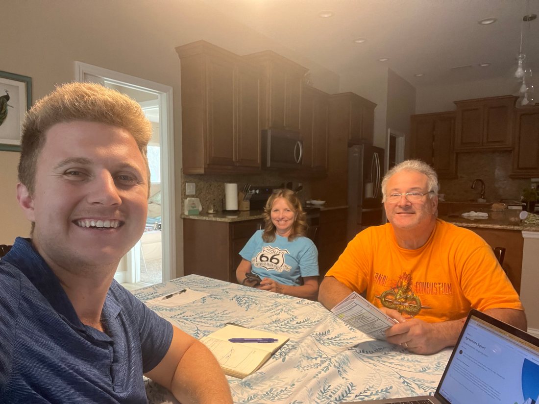 Conner Leeb with homeowners reviewing a solar agreement