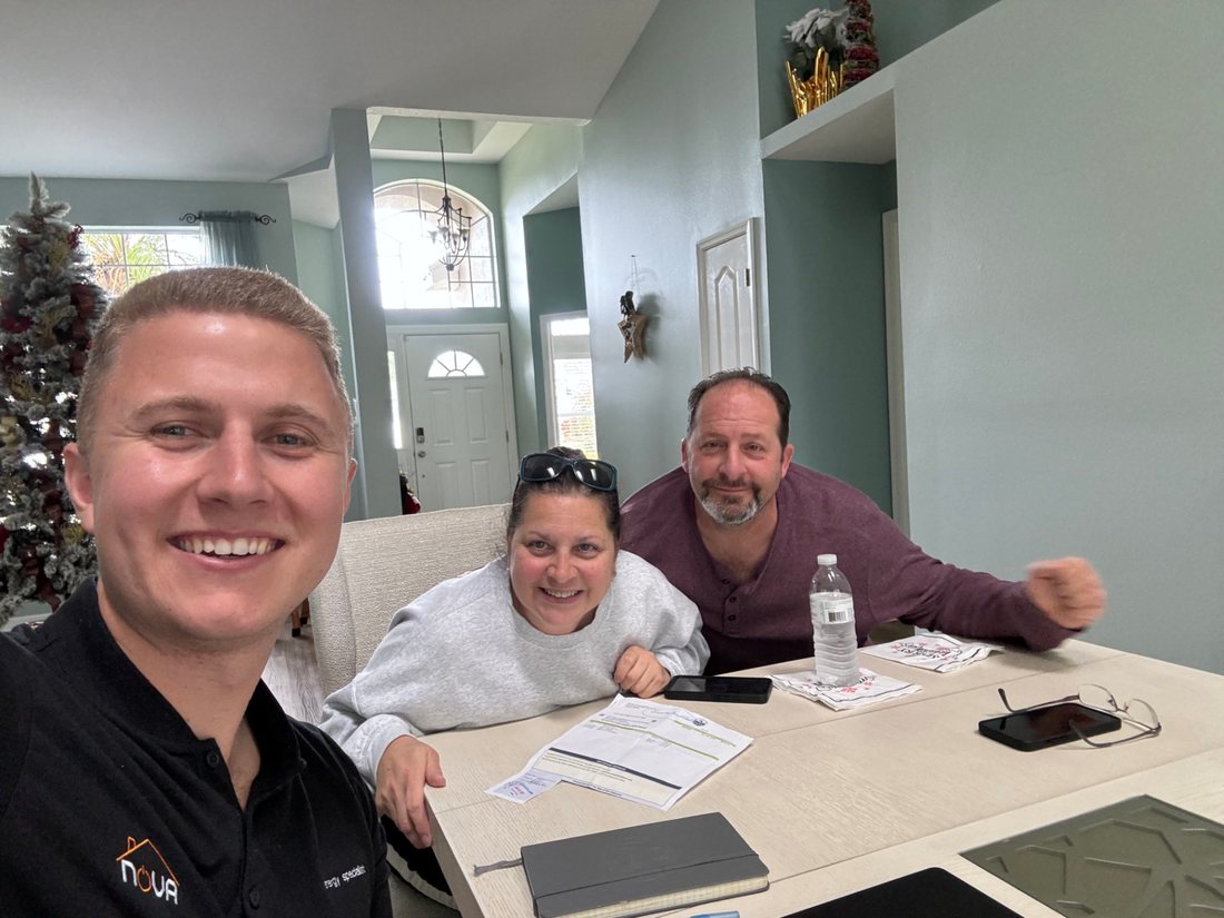 Conner Leeb with homeowners reviewing solar options