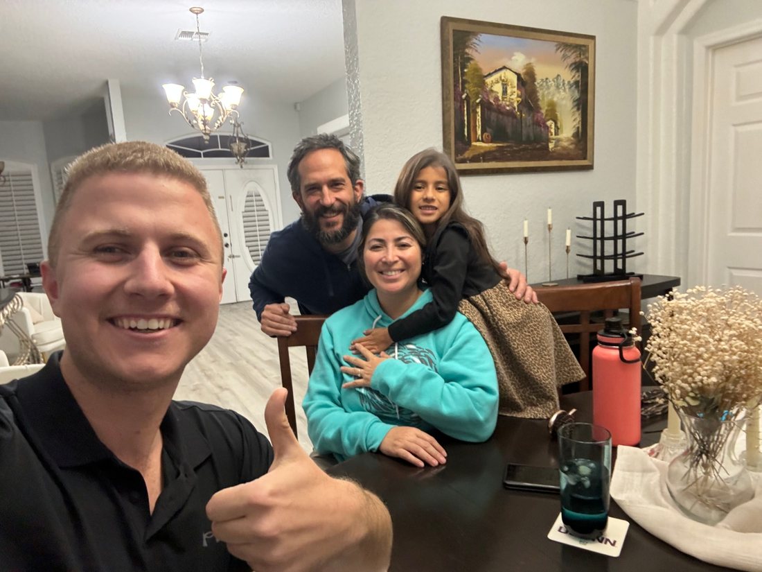 Conner Leeb with a family in their home
