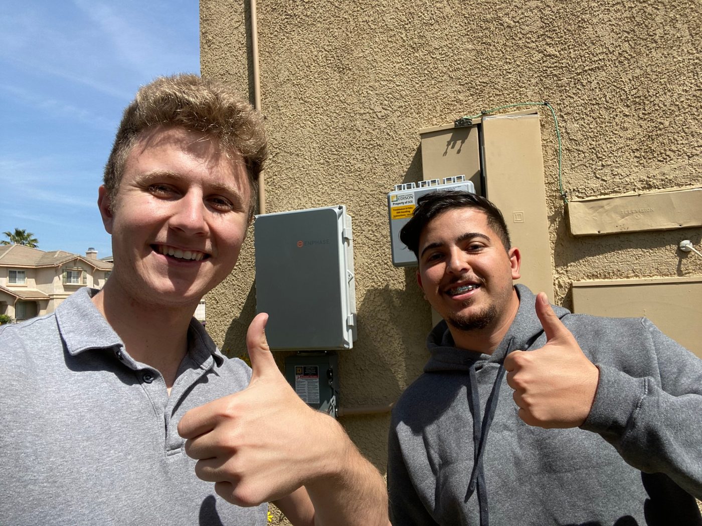 Conner Leeb with a homeowner beside his electrical equipment