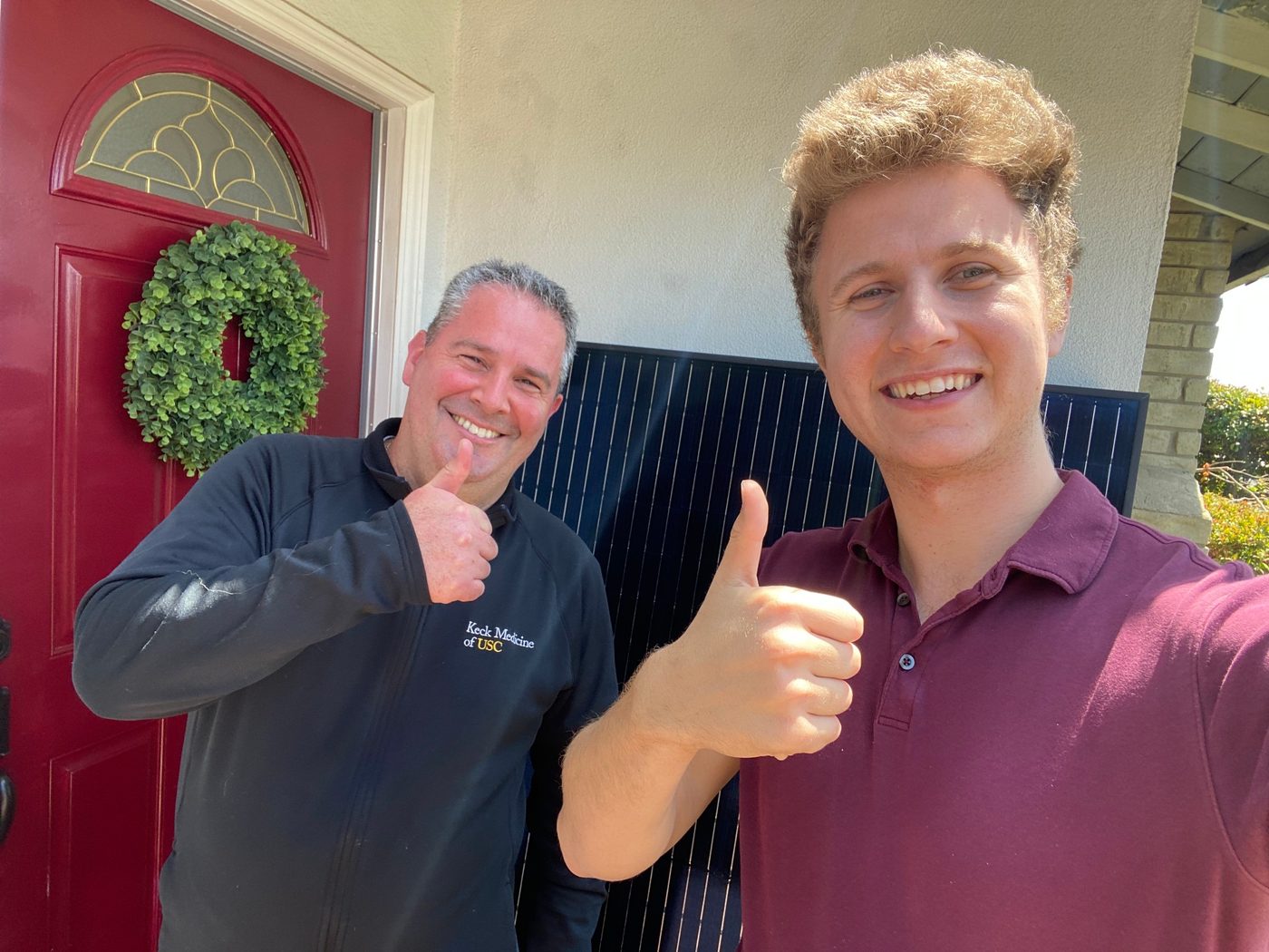 Conner Leeb and a homeowner giving a thumbs up at his front door