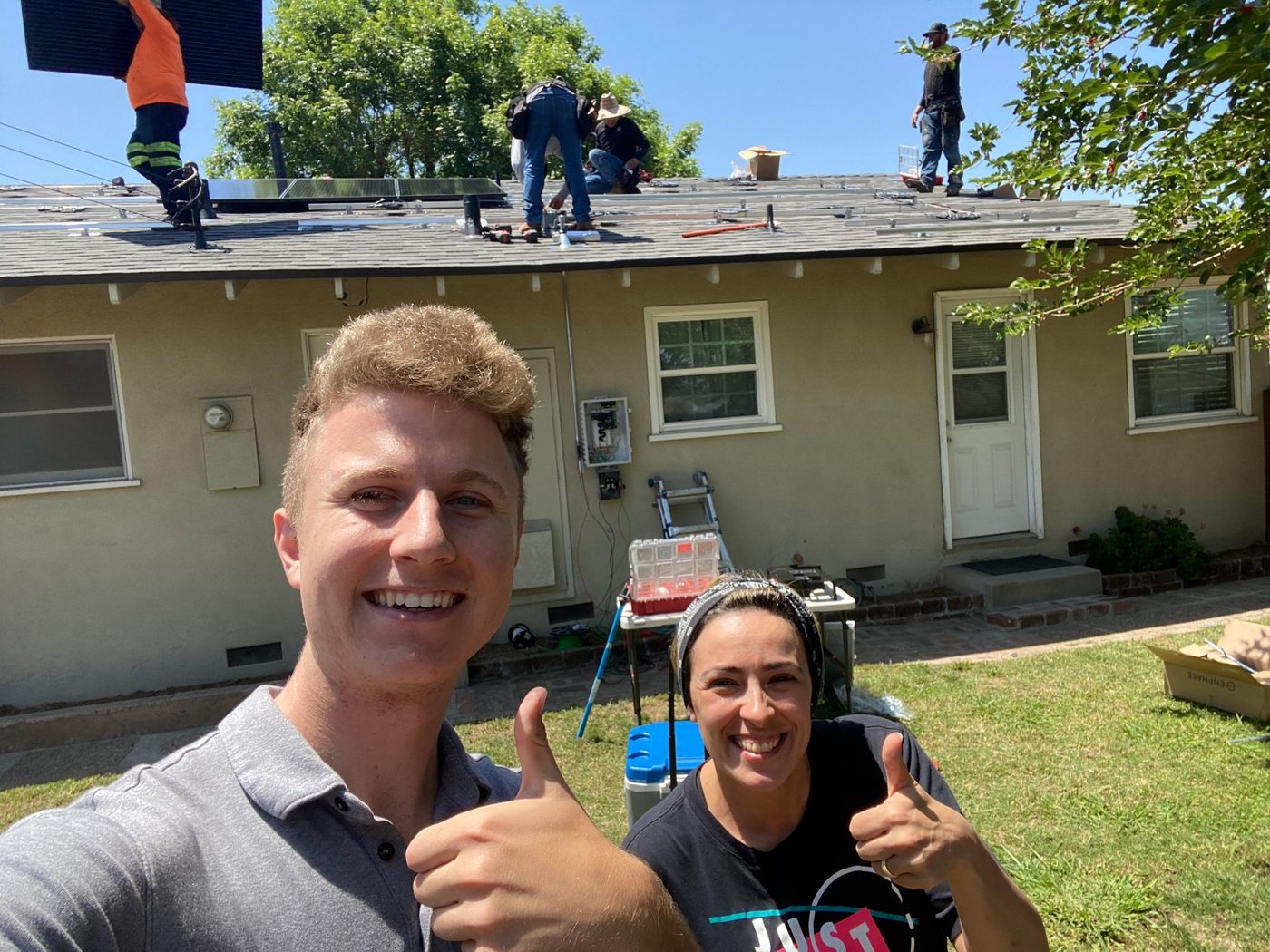 Conner Leeb and a homeowner as panels go up on her roof
