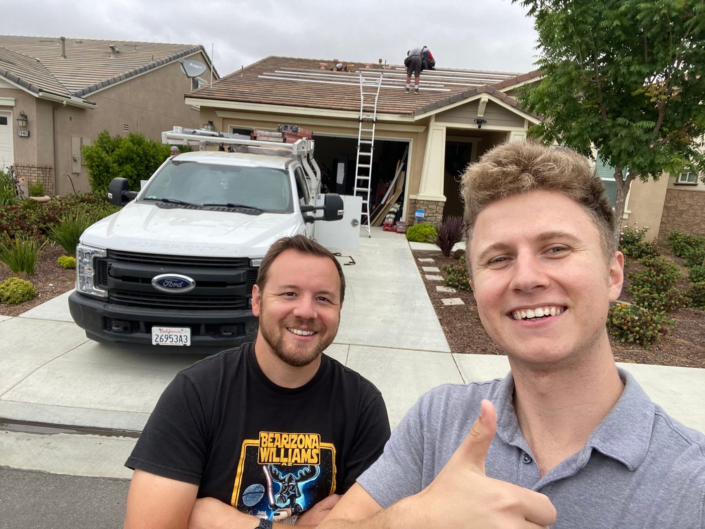 Conner Leeb with a homeowner in front of the Current Home install truck