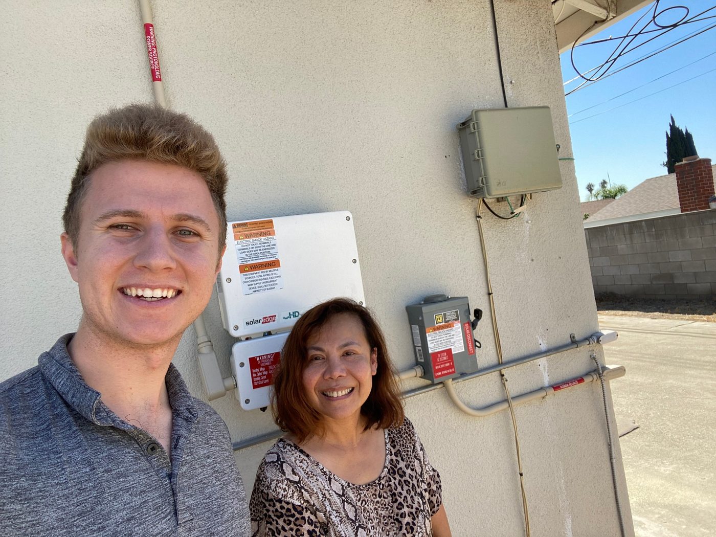 Conner Leeb with a homeowner in front of her new inverter